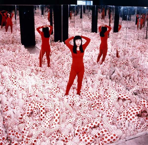 Photo of Yayoi Kusama in the Infinity Mirror Room.